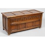 An oak panelled coffer, late19th/early 20th century, carved with a stiff leaf frieze,