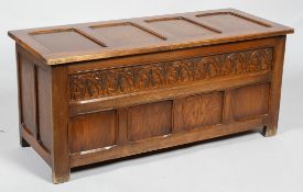 An oak panelled coffer, late19th/early 20th century, carved with a stiff leaf frieze,