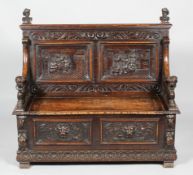 A Victorian carved oak settle,