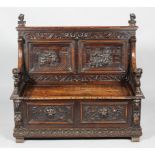 A Victorian carved oak settle,