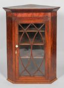 A Geeorge III mahogany corner cupbaord, of canted form,