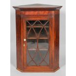 A Geeorge III mahogany corner cupbaord, of canted form,