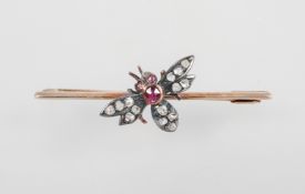 A yellow metal bar brooch having a central bee set with rose cut diamonds