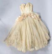 A 1950's cream silk ball gown, with cream netting and pink netting detail around the waist,