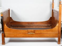 A French Empire style mahogany double bed, probably early 20th century, with turned ball finials,