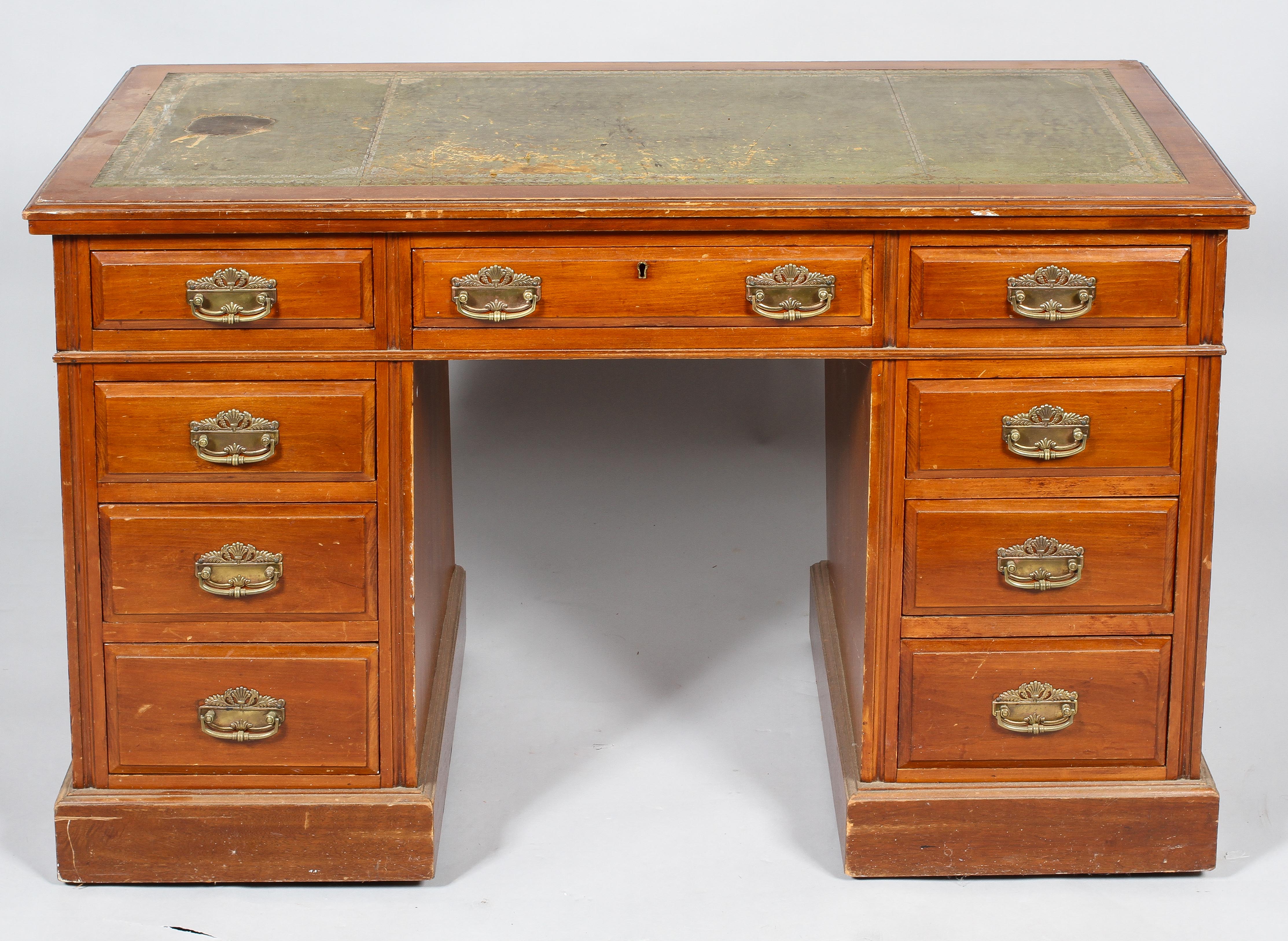 An Edwardian walnut kneehole desk,