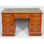 An Edwardian walnut kneehole desk,