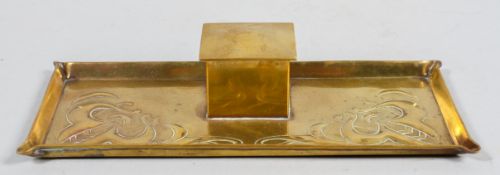 An Arts and Crafts brass inkwell, with embossed decoration, witted with a ceramic inkwell, 4.