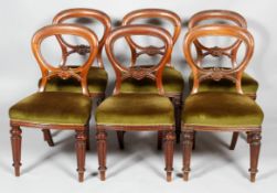 Six Victorian mahogany balloon back dining chairs, with pierced carved foliate back rail,