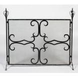 A large painted steel wrought iron fire screen, with globe coronet style finials,