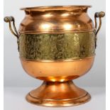An Edwardian copper and brass two handled footed waste paper bin, of oviform shape,