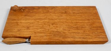 An oak cheese board with carved mouse, the inset cheese knife labelled B A Oxley, Windsor, 33.