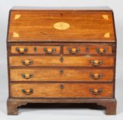 A George III mahogany inlaid bureau,