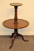 A George III mahogany two-tier dumb waiter with small circular upper tier with moulded rims