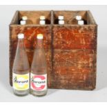 A vintage 20th century wooden crate with twelve empty glass Corona sparkling orangeade and lemonade