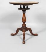 A George III elm small tilt top occasional table, with bird cage gallery above turned baluster stem,