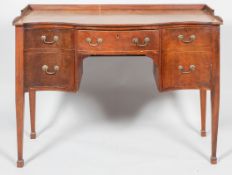 An early 19th century Regency serpentine sideboard with low gallery,
