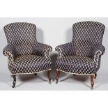 A pair of Victorian upholstered wing armchairs, with carved cabriole legs and casters,