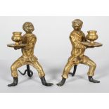 A pair of late Victorian gilt brass monkey candlesticks,
