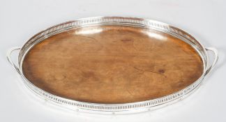 A silver plated and wooden pierced oval gallery tray, 20th century, with loop handles,