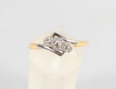 An illusion set three stone diamond ring, the eight cut stones at 1.