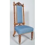 A Victorian walnut nursing chair, with high back and stuff-over seats,
