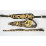 Three leather mounted horse brasses,