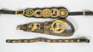 Three leather mounted horse brasses,