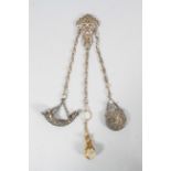 A silver chatelaine, of baroque form, with pierced and hinged waist piece,