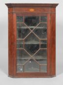 A George III mahogany glazed corner cupboard, with geometric astragals,
