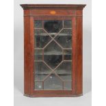 A George III mahogany glazed corner cupboard, with geometric astragals,