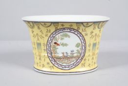 A Chinese porcelain yellow ground flared cylindrical jardiniere,