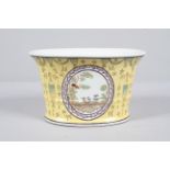 A Chinese porcelain yellow ground flared cylindrical jardiniere,