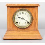 An American Session mantel clock, the movement striking on a gong, in oak case,