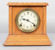 An American Session mantel clock, the movement striking on a gong, in oak case,