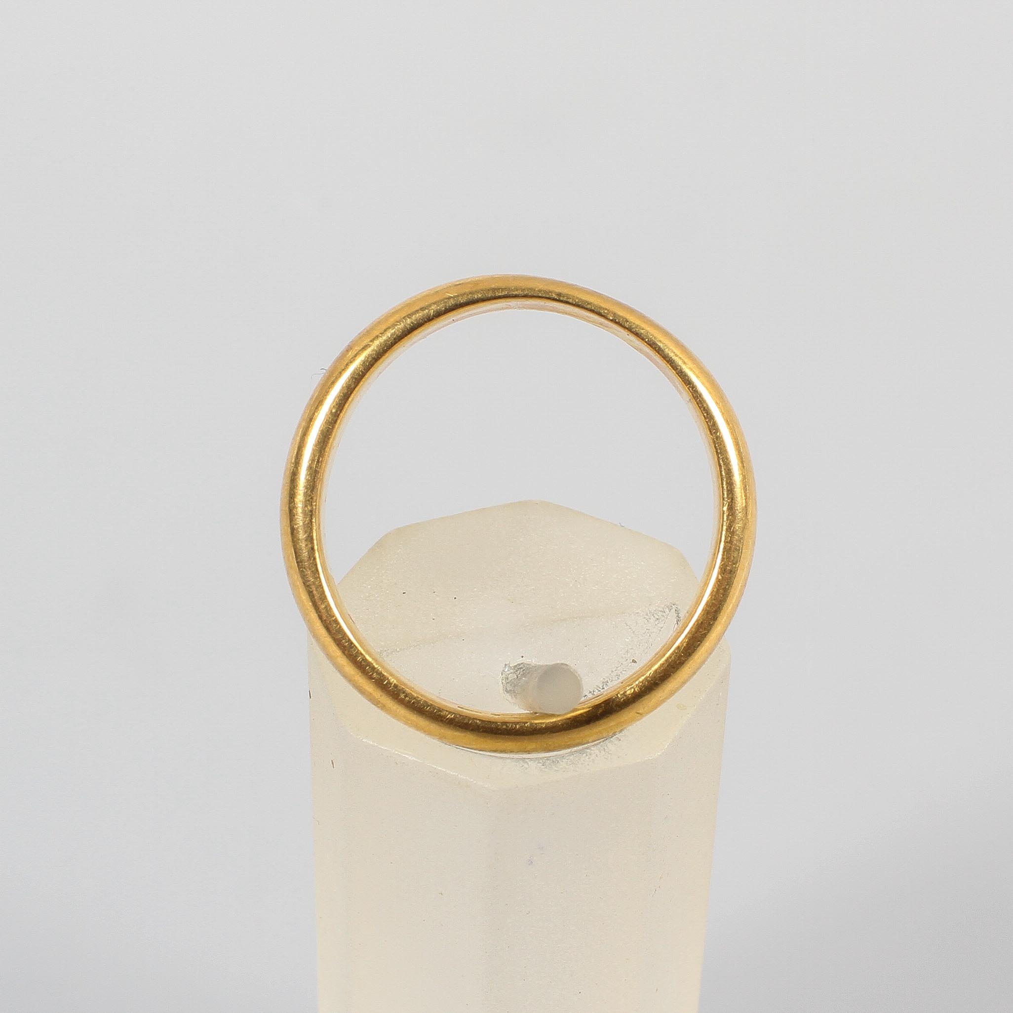 A yellow metal 4.5mm court shaped wedding ring. Hallmarked 22ct gold, Birmingham, 1925. Size: M 7. - Image 2 of 3