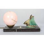 An Art Deco gilt metal and marble mounted desk lamp with pink opaque globe shade,