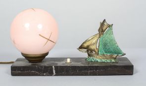 An Art Deco gilt metal and marble mounted desk lamp with pink opaque globe shade,