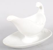 A Continental porcelain white sauce boat and stand, with lion terminal,