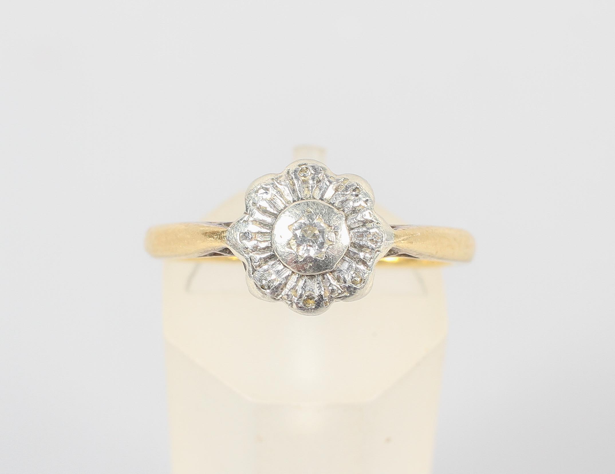 A yellow and white metal illusion set single stone diamond ring. No hallmark - stamped 18ct Plat.