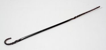 A Victorian amber tinted walking stick, with spiral crook handle and lower part,