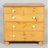 A Victorian pine chest of drawers, comprising two short drawers above three graduated long drawers,