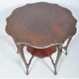 An Edwardian mahogany occasional table having scalloped and bevelled edge with undertier,