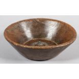 A 19th century carved oak bowl, inset silver mount with turquoise centre, probably Nepal,