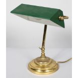 A vintage early 20th century gilt metal and enamel desk lamp, with green enamelled adjustable shade,