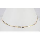 A 17 inch yellow and white metal twisted flat herringbone necklace. Bolt ring clasp.