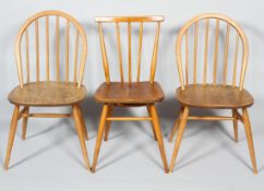 Three Ercol pale beech and elm stick back kitchen chairs,