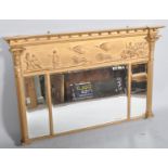 A Regency 19th century gilt and gesso moulded triple panel over mantle mirror having scenes of