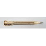 A filled gold propelling pencil, of seal end type, round form with panels of chevron engine turning,