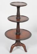 A mahogany George III style miniature three tier dumb waiter, with moulded rims,
